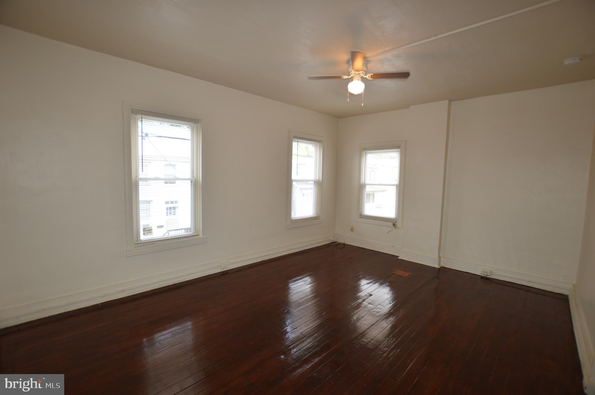 482 West South Street Frederick, MD 21701 - Photo 8 of 14 a view of an empty room with wooden floor and a window
