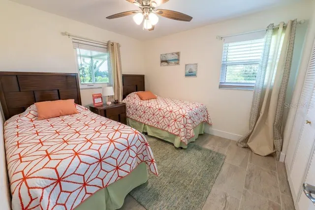 a bedroom with two beds and a chandelier