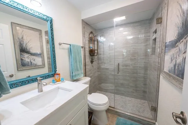 a bathroom with a sink toilet and shower