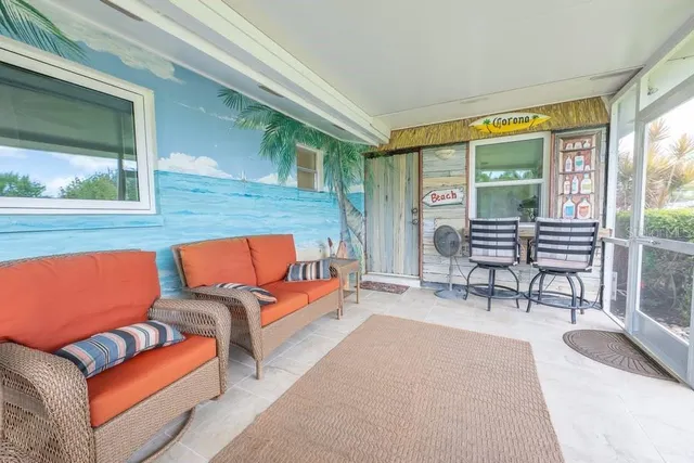 a outdoor living space with patio furniture and a large window