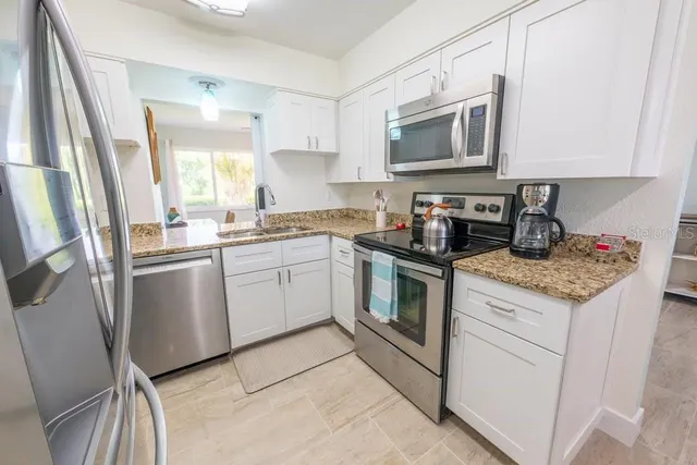 a kitchen with a sink stove and microwave