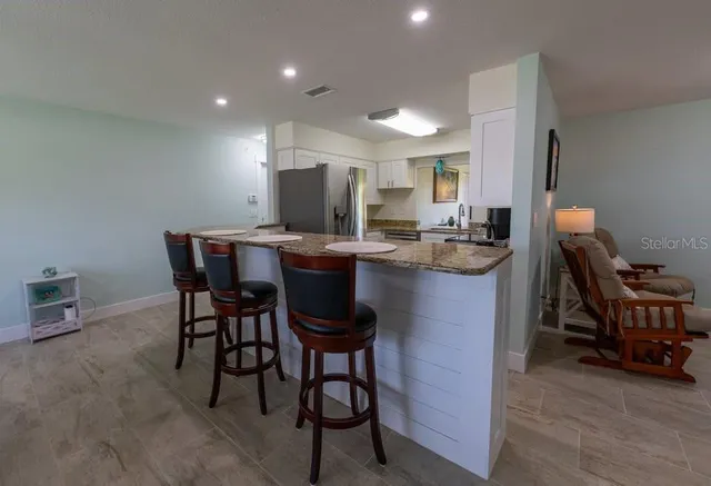 a kitchen with a table chairs and a refrigerator
