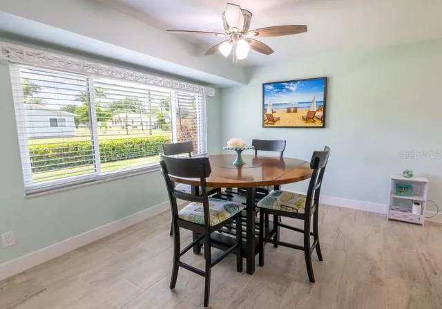 a view of a dining room with furniture window and outside view