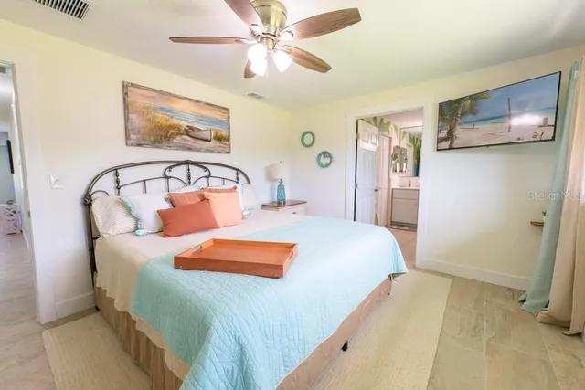 a bedroom with a bed and a chandelier