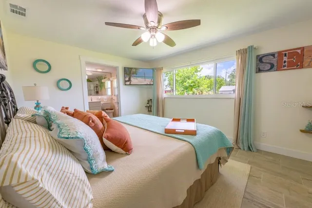 a bedroom with a bed and a window