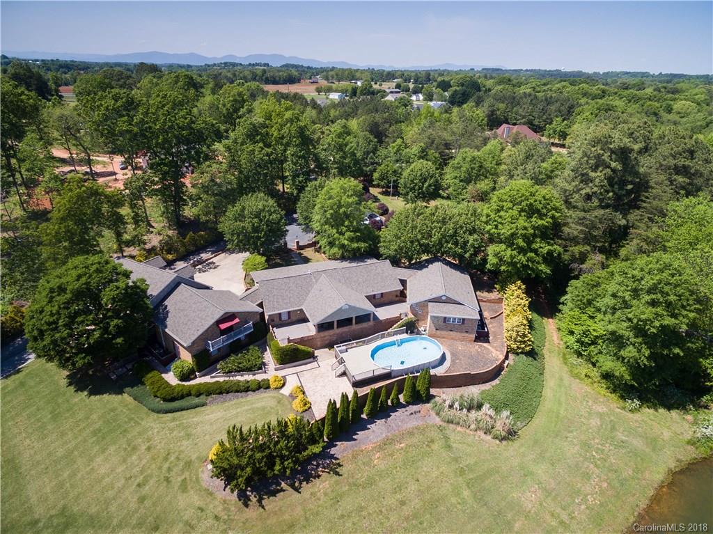 an aerial view of a house with garden space and street view