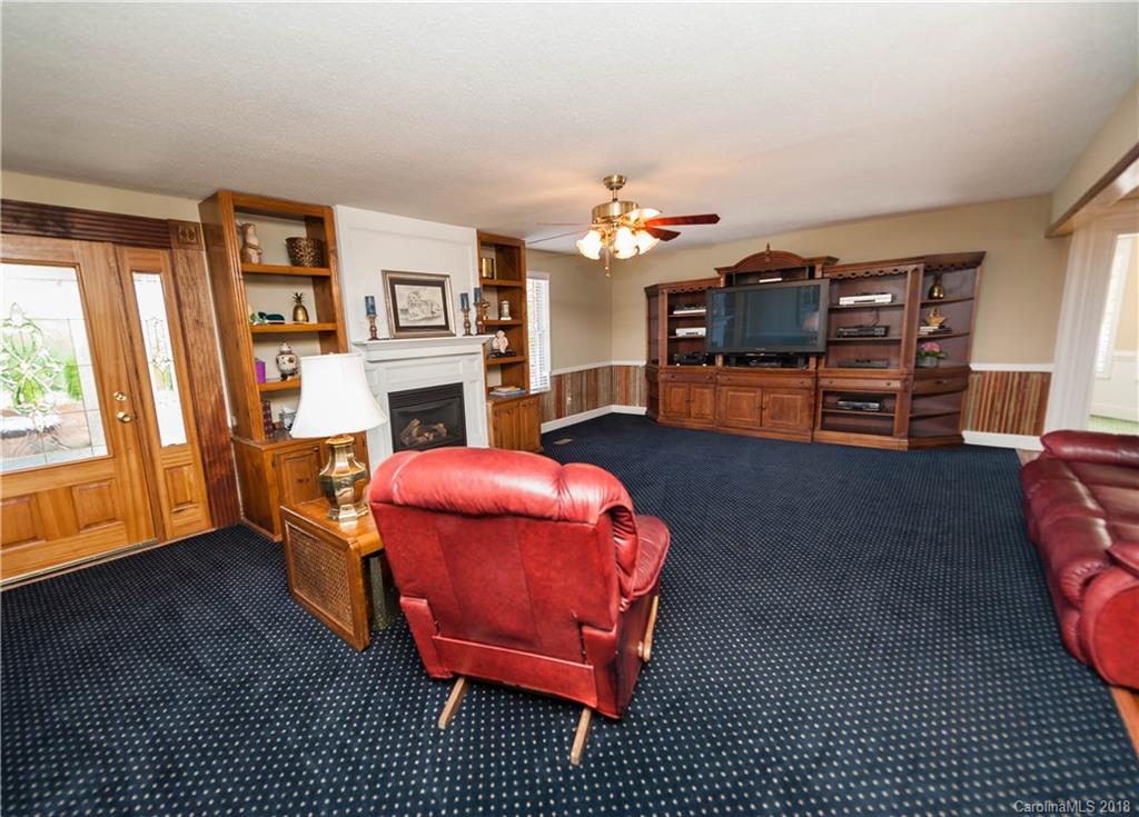 1491 Ballenger Road Inman, SC 29349 - Photo 18 of 35 a living room with furniture a fireplace and a flat screen tv