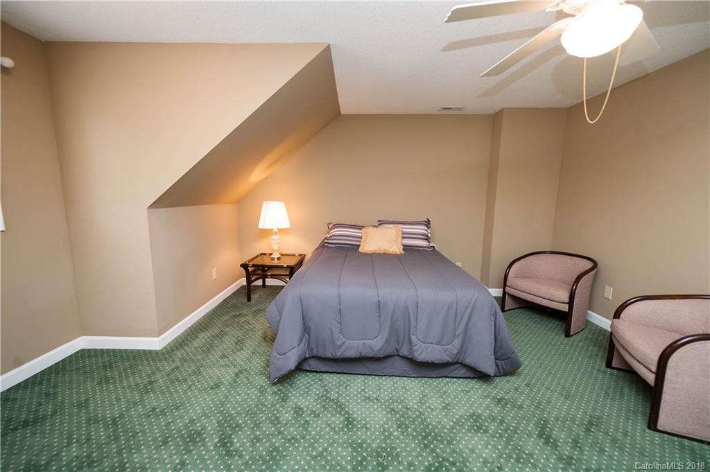 1491 Ballenger Road Inman, SC 29349 - Photo 22 of 35 a bedroom with a bed and a chandelier