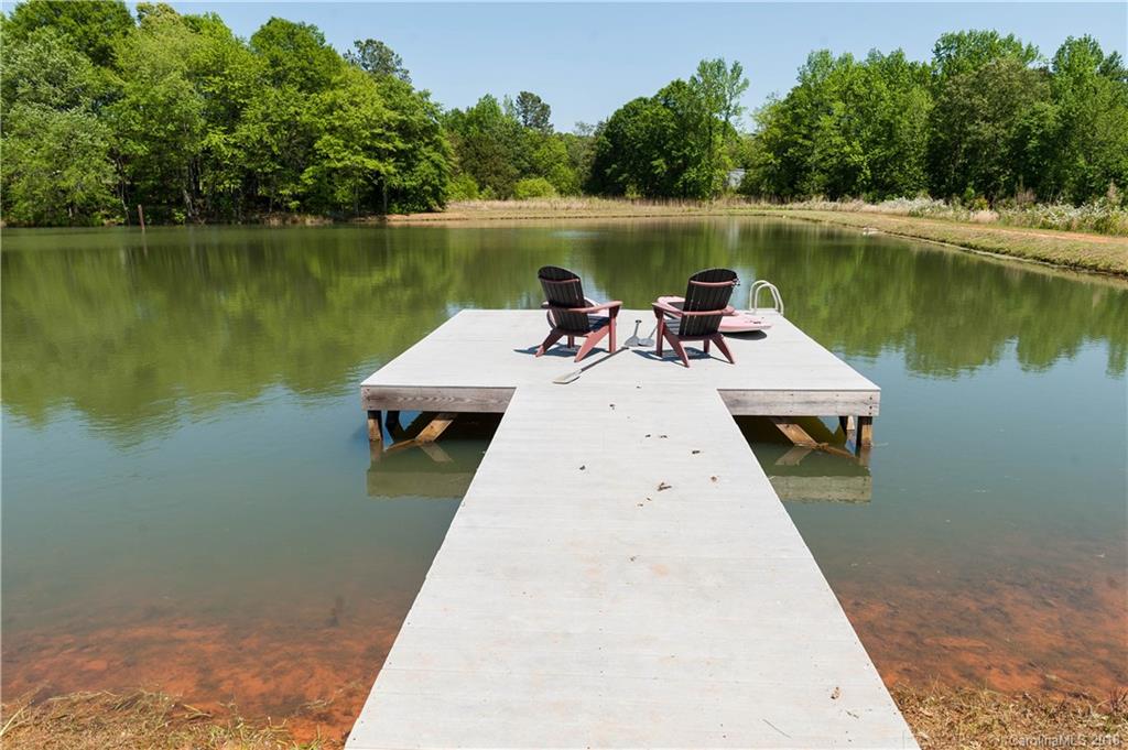 1491 Ballenger Road Inman, SC 29349 - Photo 34 of 35 a wooden pier with boats and a lake view