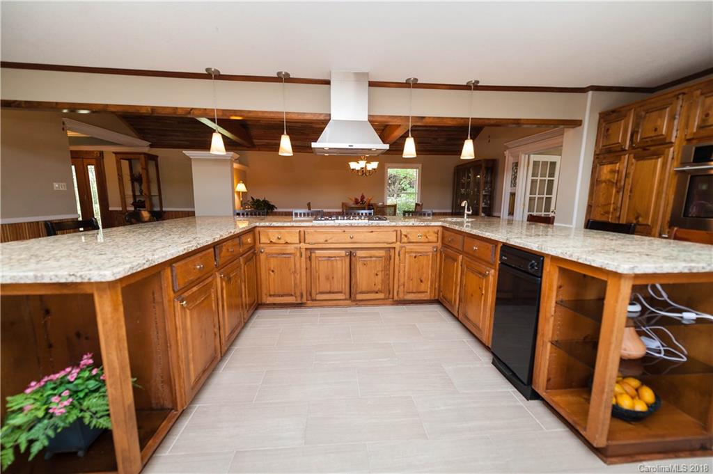 1491 Ballenger Road Inman, SC 29349 - Photo 10 of 35 a kitchen with stainless steel appliances granite countertop a sink and wooden cabinets