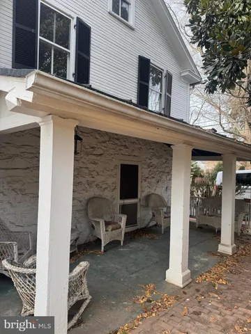 a view of a house with a barbeque grill and a fireplace