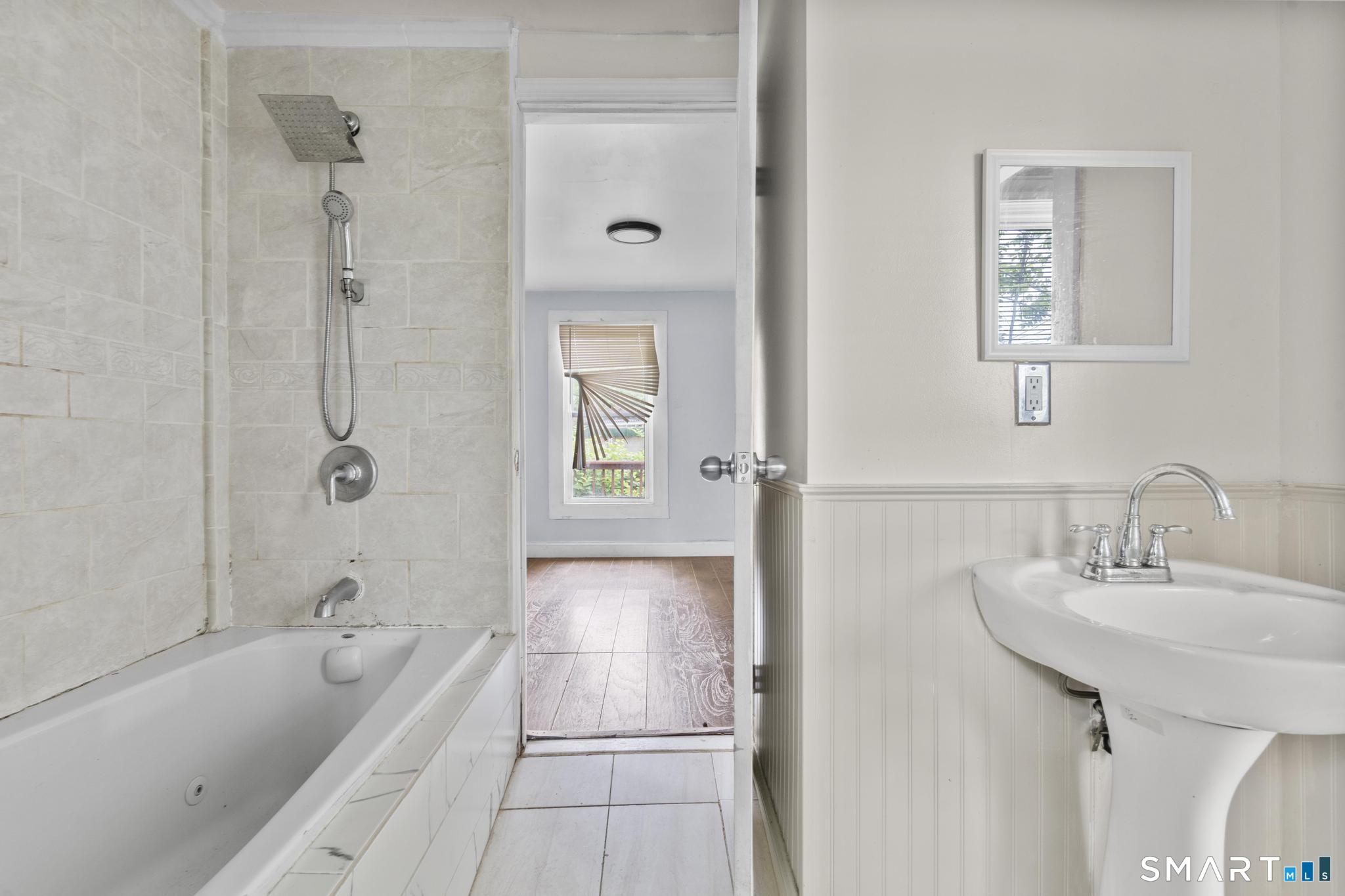 101 Meridian Street Meriden, CT 06451 - Photo 21 of 26 a bathroom with a tub shower and a sink