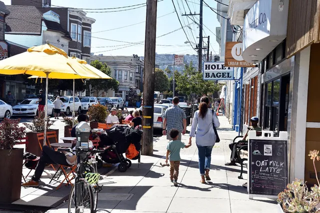 a group of people sitting under an umbrella