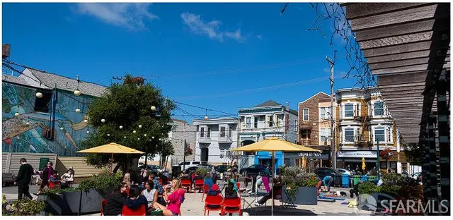 a area with lots of people and umbrellas