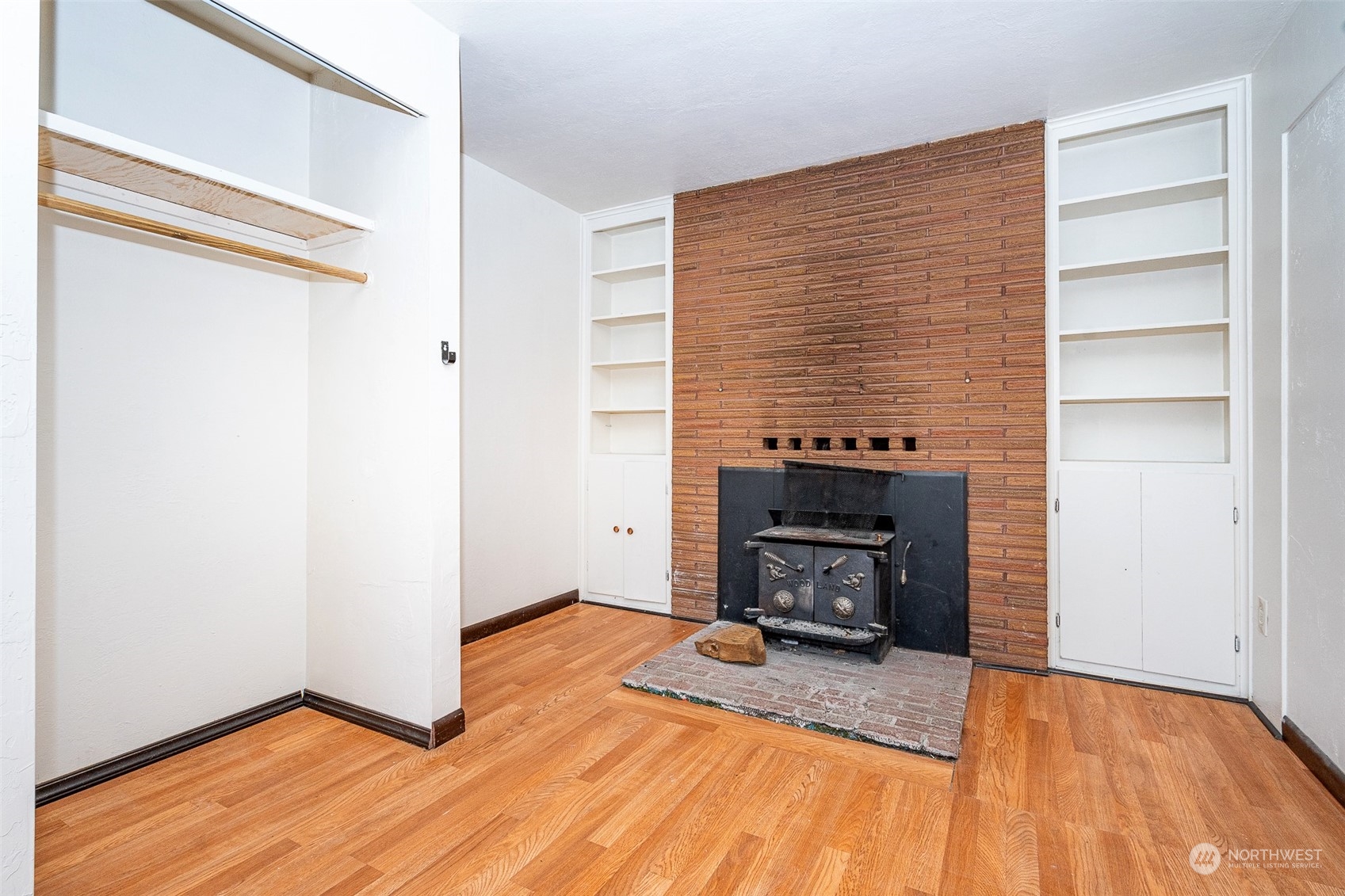 738 Southwest 19th Street Chehalis, WA 98532 - Photo 17 of 40 a view of an empty room with wooden floor fire place and a window