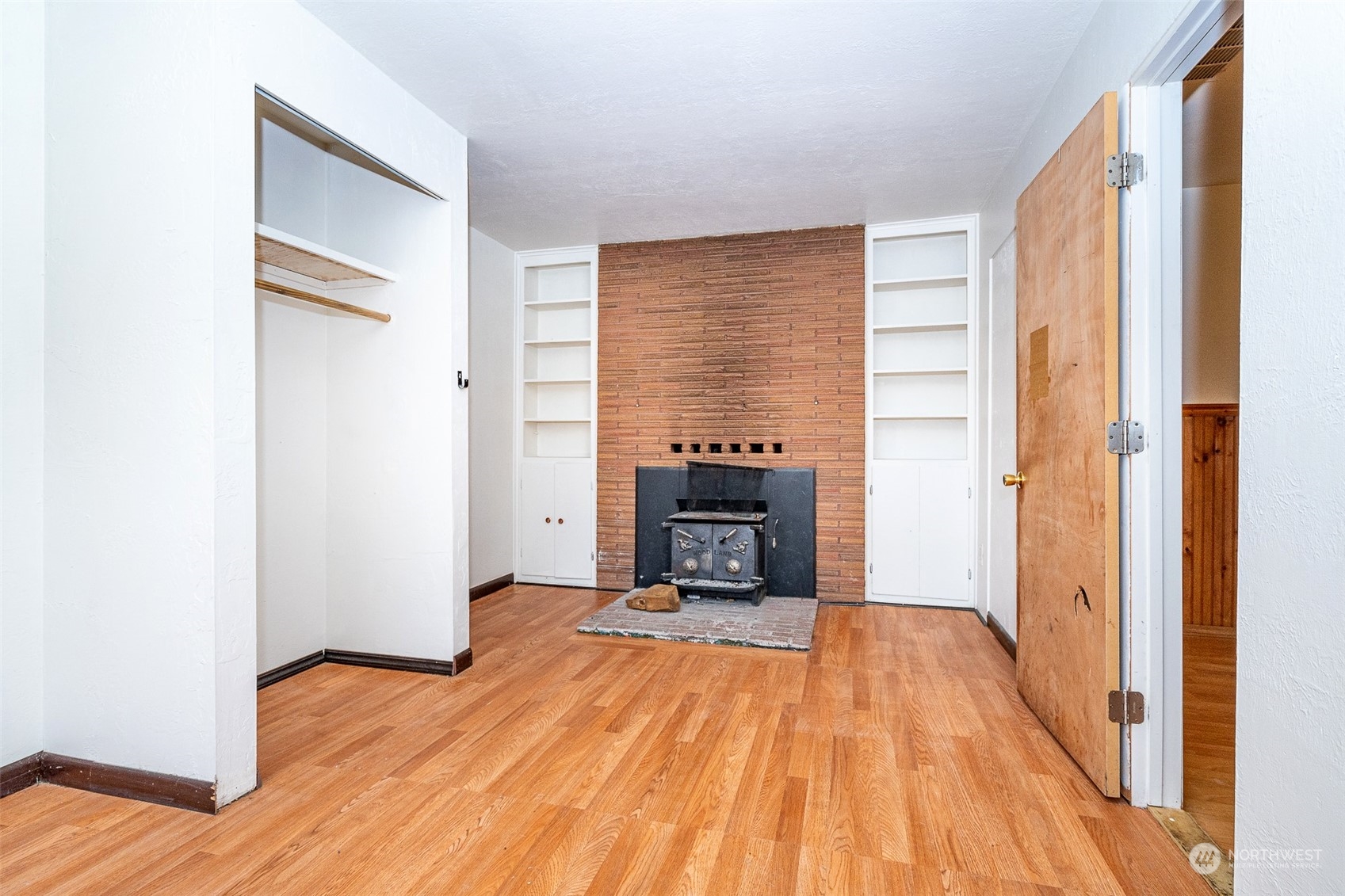 738 Southwest 19th Street Chehalis, WA 98532 - Photo 18 of 40 a view of empty room with wooden floor and fireplace