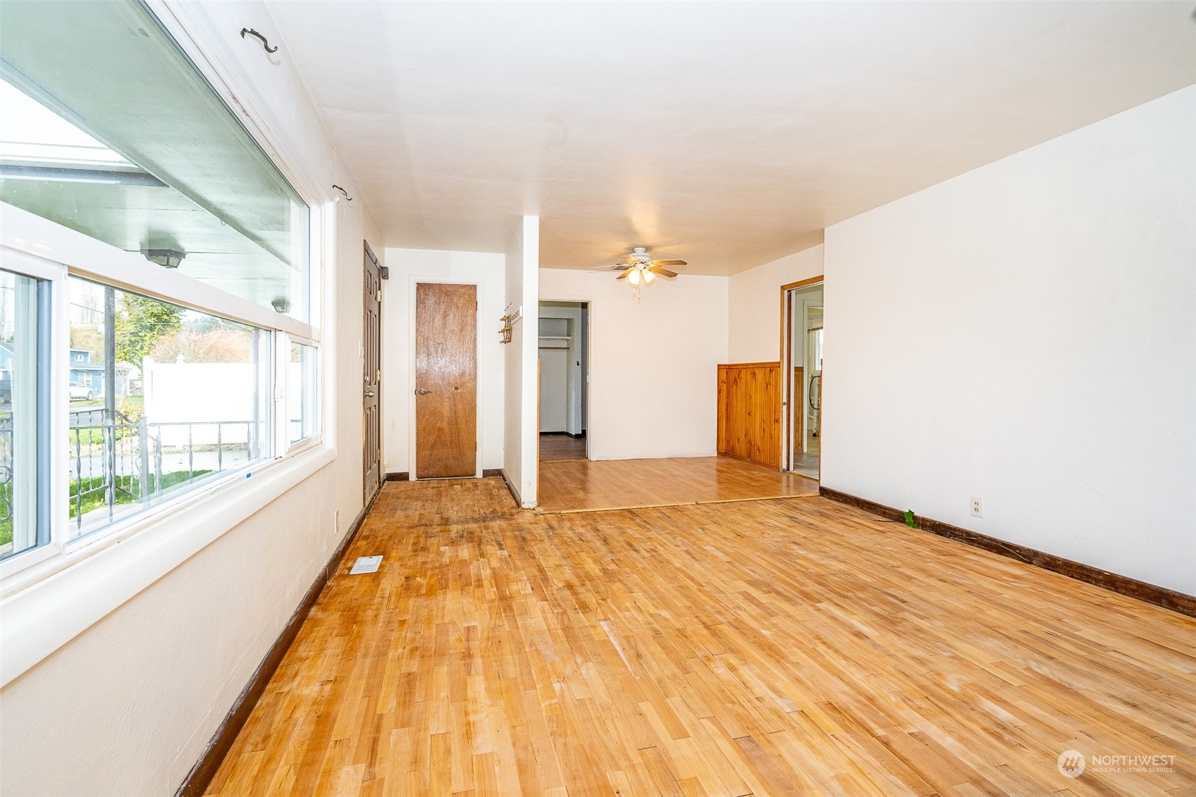 738 Southwest 19th Street Chehalis, WA 98532 - Photo 7 of 40 a view of an empty room with wooden floor and a window