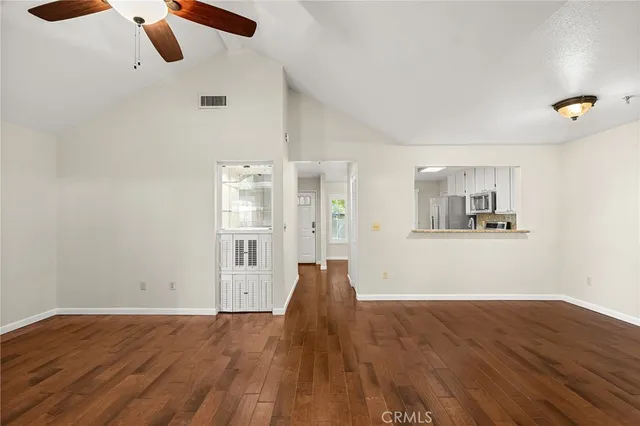 a view of empty room with wooden floor