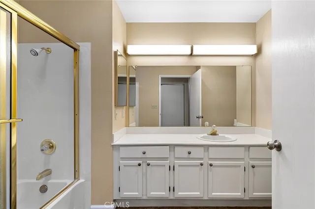 a bathroom with a sink vanity tub and a mirror