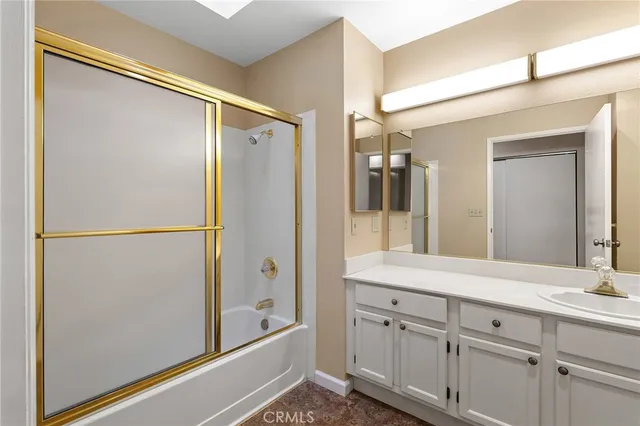a bathroom with a double vanity sink a mirror and a shower