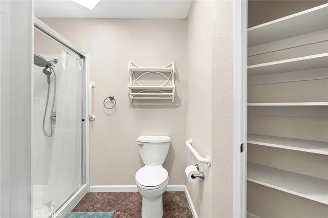 a bathroom with a toilet and a shower