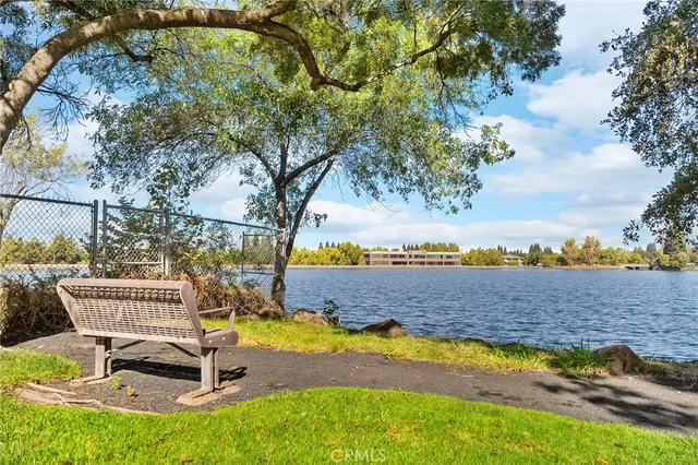 a view of a swimming pool with lawn chairs and couches