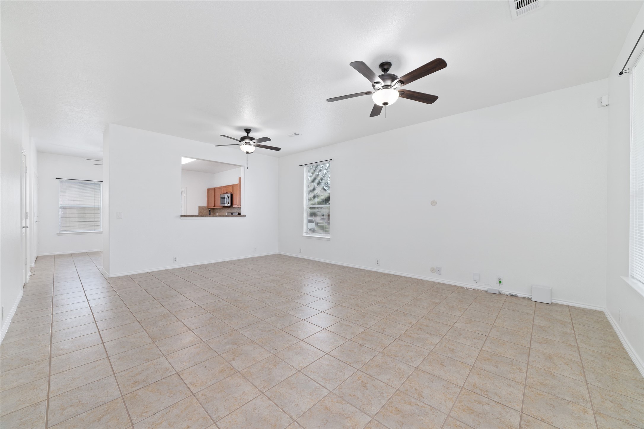23602 Youpon Lake Lane Spring, TX 77373 - Photo 3 of 21 Bright living area with large windows, ceiling fans, and an open layout.