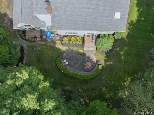 19 West Gate Road Suffern, NY 10901 - Photo 10 of 42 Expansive backyard featuring a stone patio surrounded by a low stone wall and manicured hedges