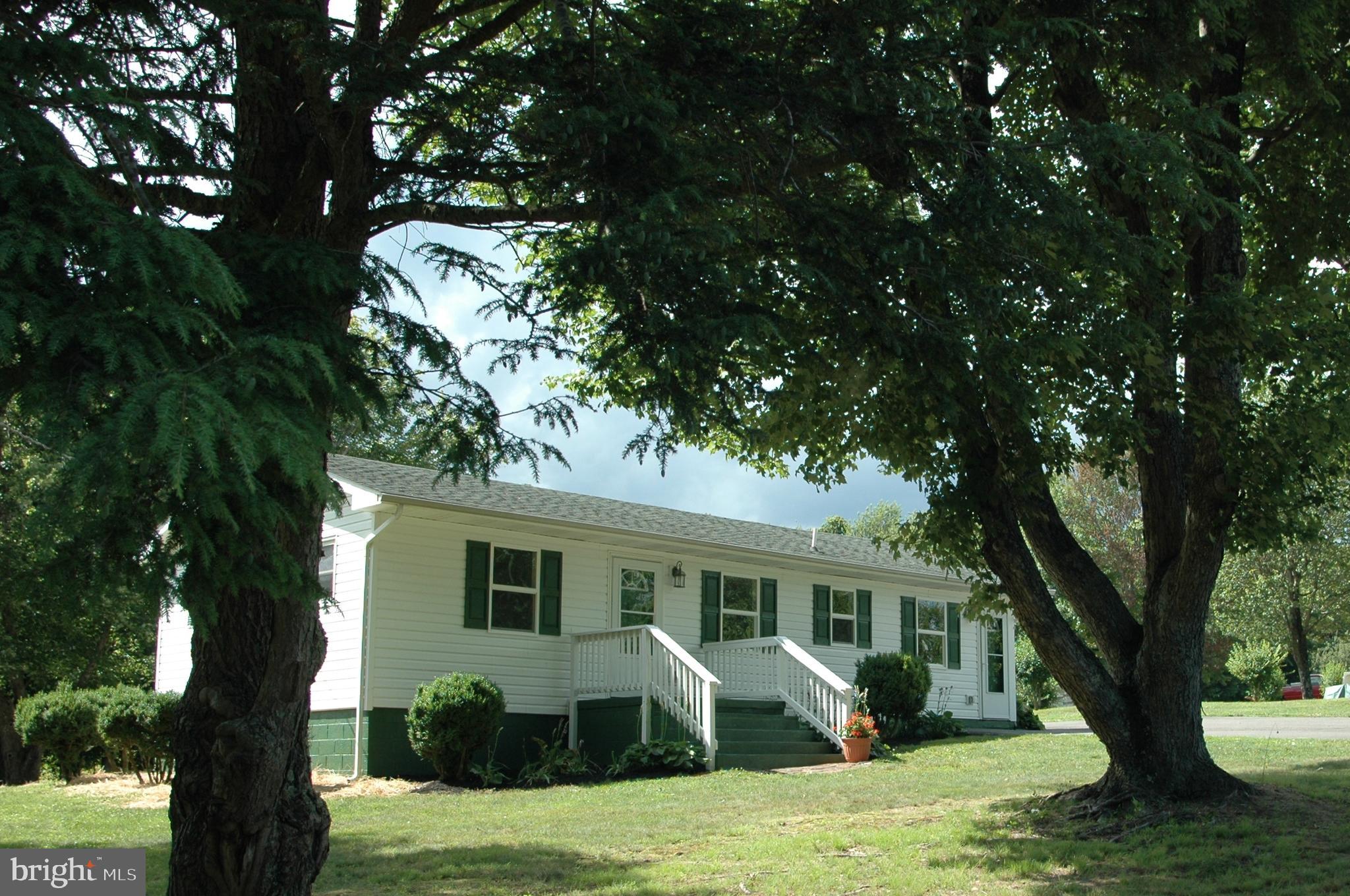 251 Scrabble Road Castleton, VA 22716 - Photo 1 of 23 a front view of a house with garden