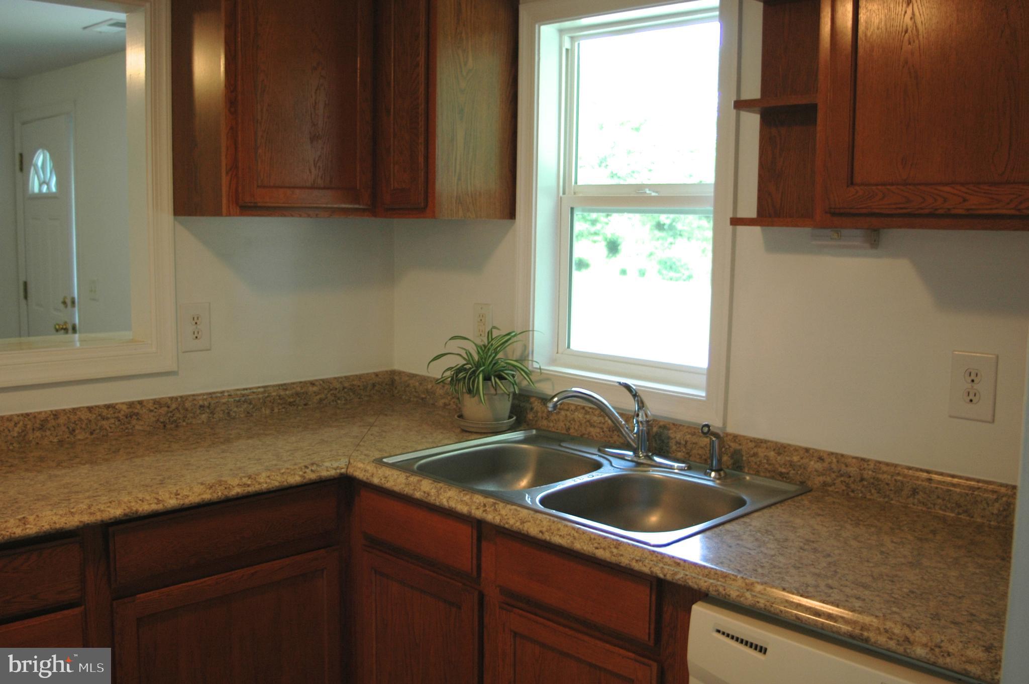 251 Scrabble Road Castleton, VA 22716 - Photo 5 of 23 a kitchen with a sink cabinets and window