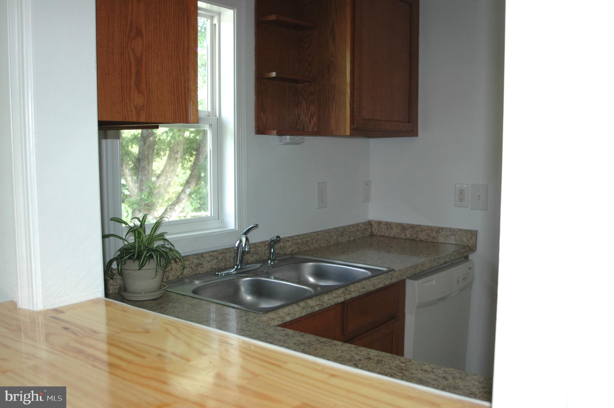 251 Scrabble Road Castleton, VA 22716 - Photo 9 of 23 a kitchen with granite countertop a sink and a window
