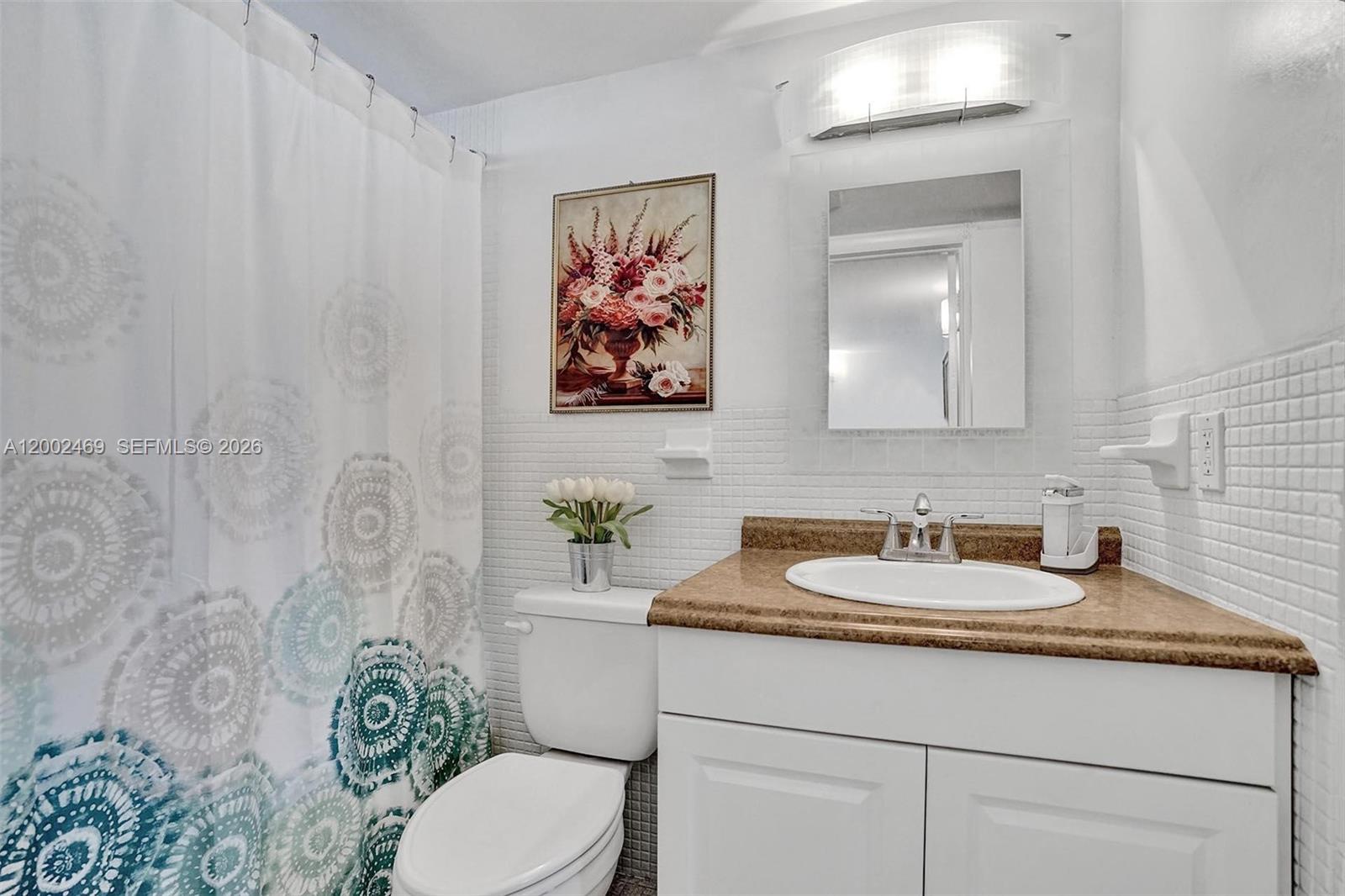 2999 Point E Drive, Unit C511 Aventura, FL 33160 - Photo 13 of 33 a bathroom with a granite countertop sink mirror vanity and toilet