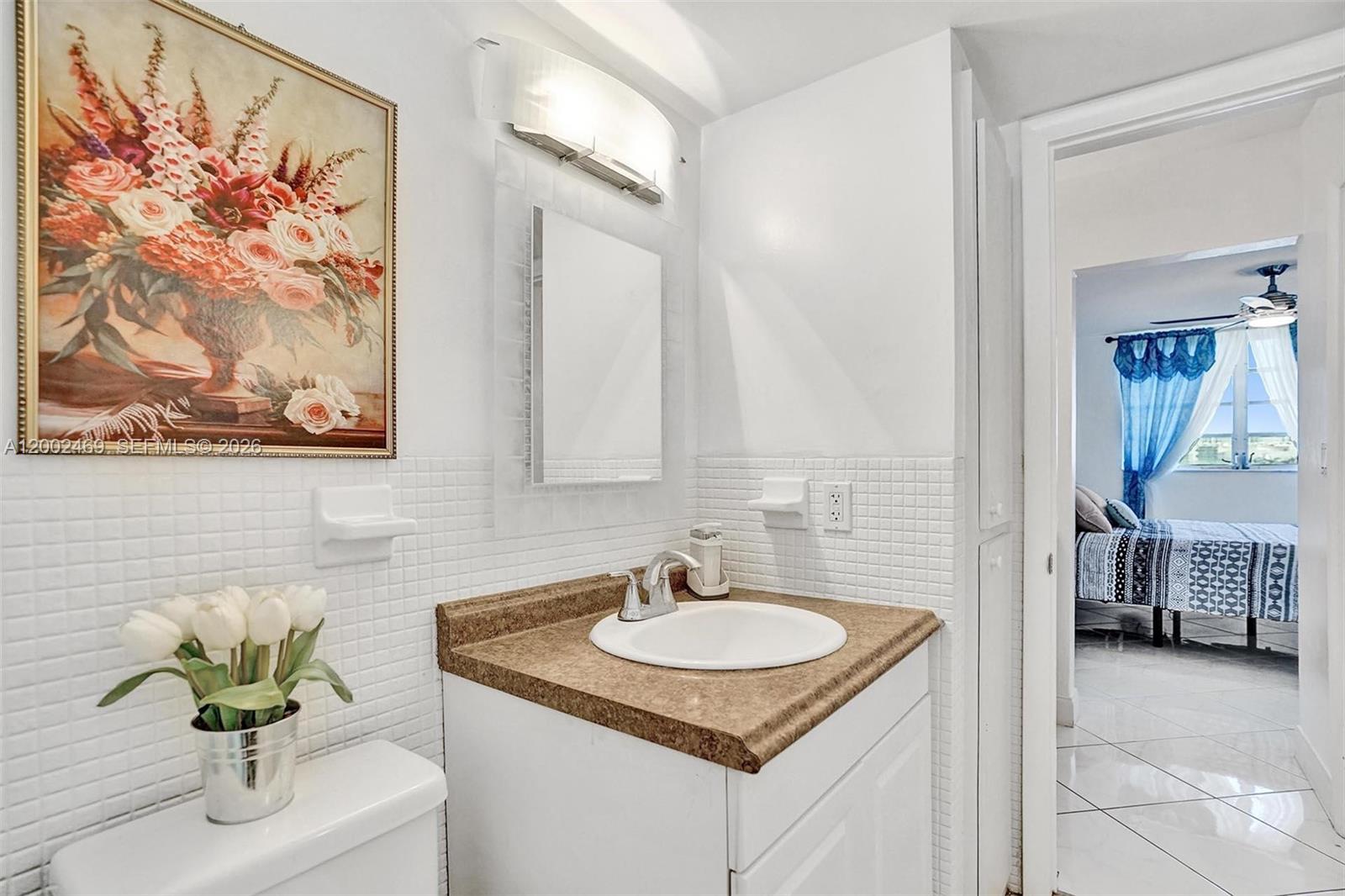 2999 Point E Drive, Unit C511 Aventura, FL 33160 - Photo 14 of 33 a bathroom with a sink and a mirror