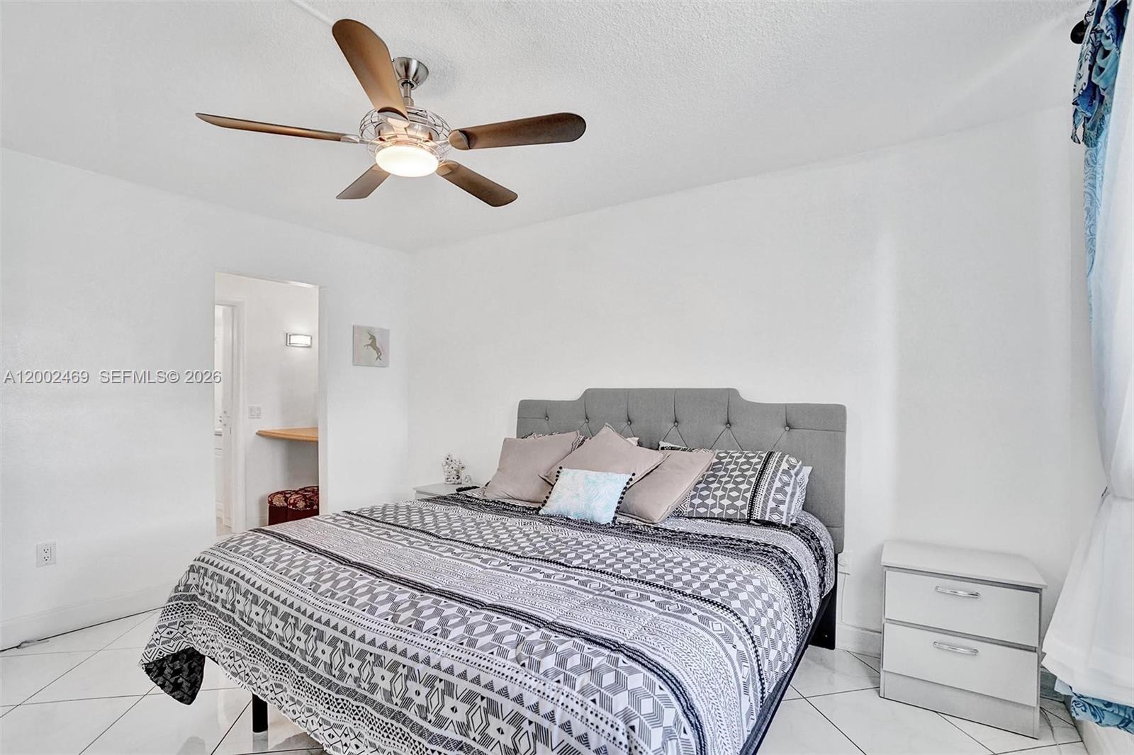 2999 Point E Drive, Unit C511 Aventura, FL 33160 - Photo 19 of 33 a bedroom with a bed and a ceiling fan