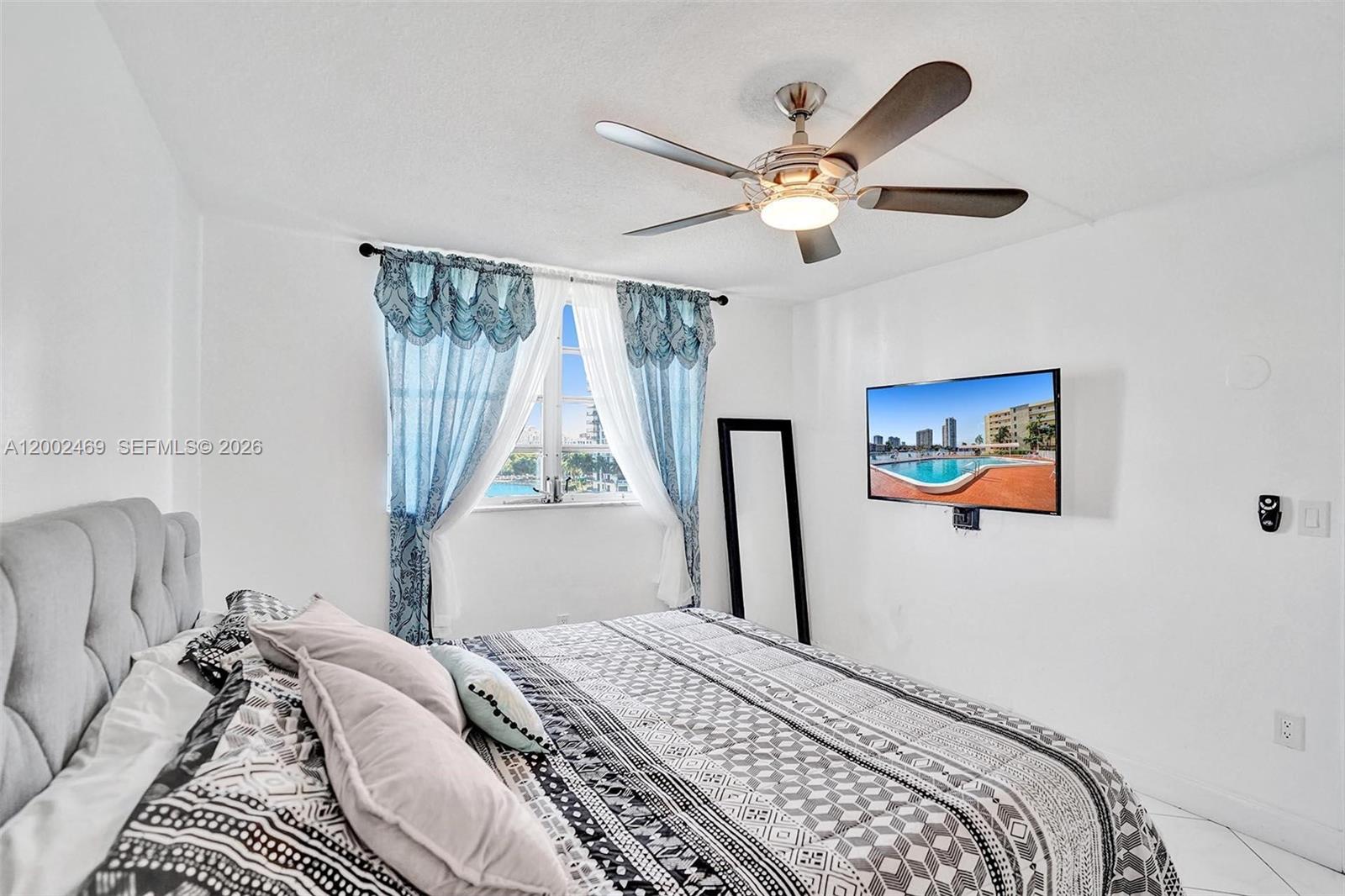2999 Point E Drive, Unit C511 Aventura, FL 33160 - Photo 21 of 33 a bedroom with a large bed and a window