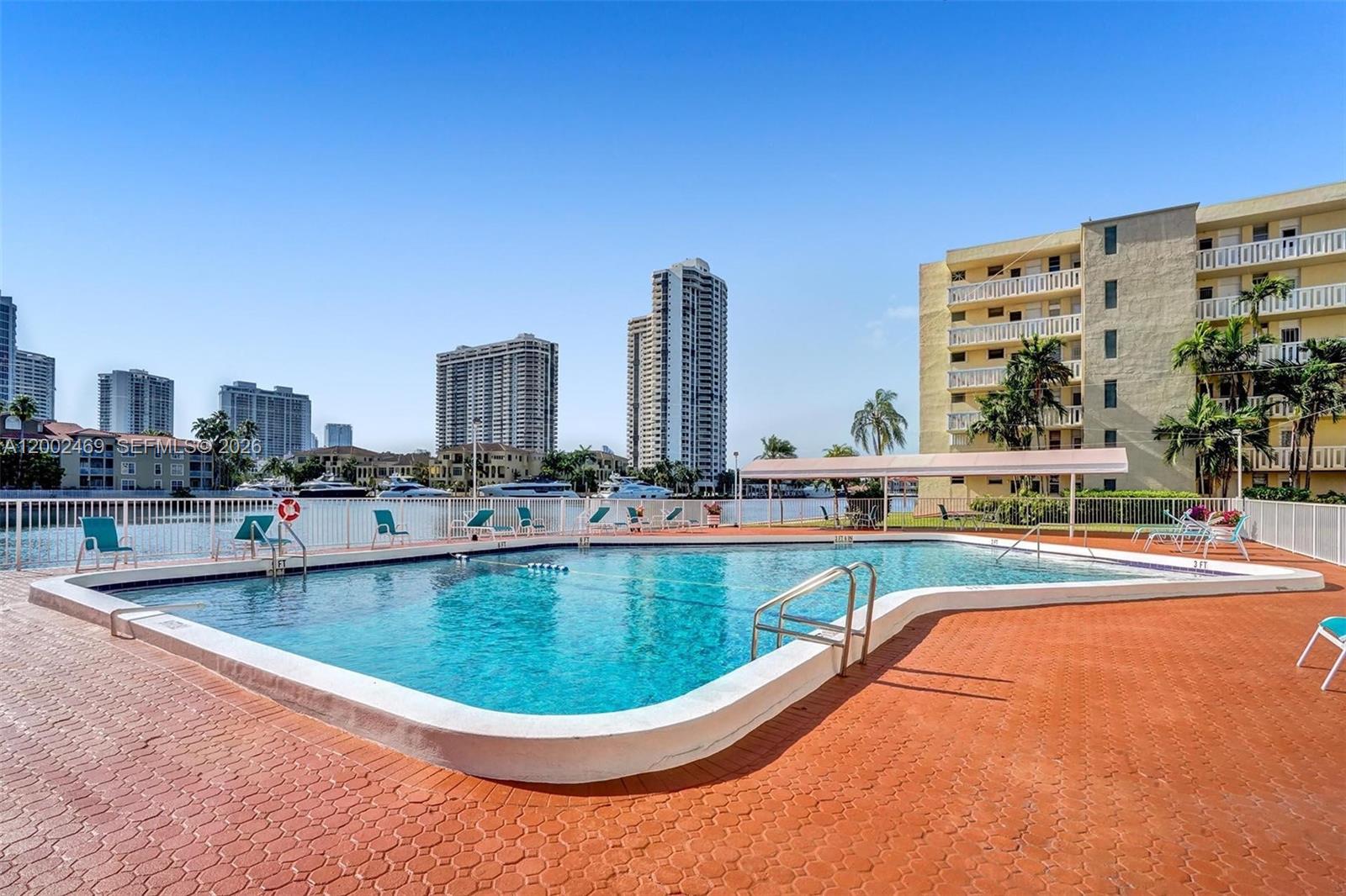 2999 Point E Drive, Unit C511 Aventura, FL 33160 - Photo 29 of 33 a view of a swimming pool with outdoor seating