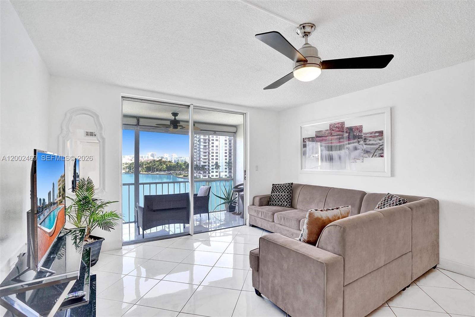 2999 Point E Drive, Unit C511 Aventura, FL 33160 - Photo 3 of 33 a living room with furniture and a fireplace