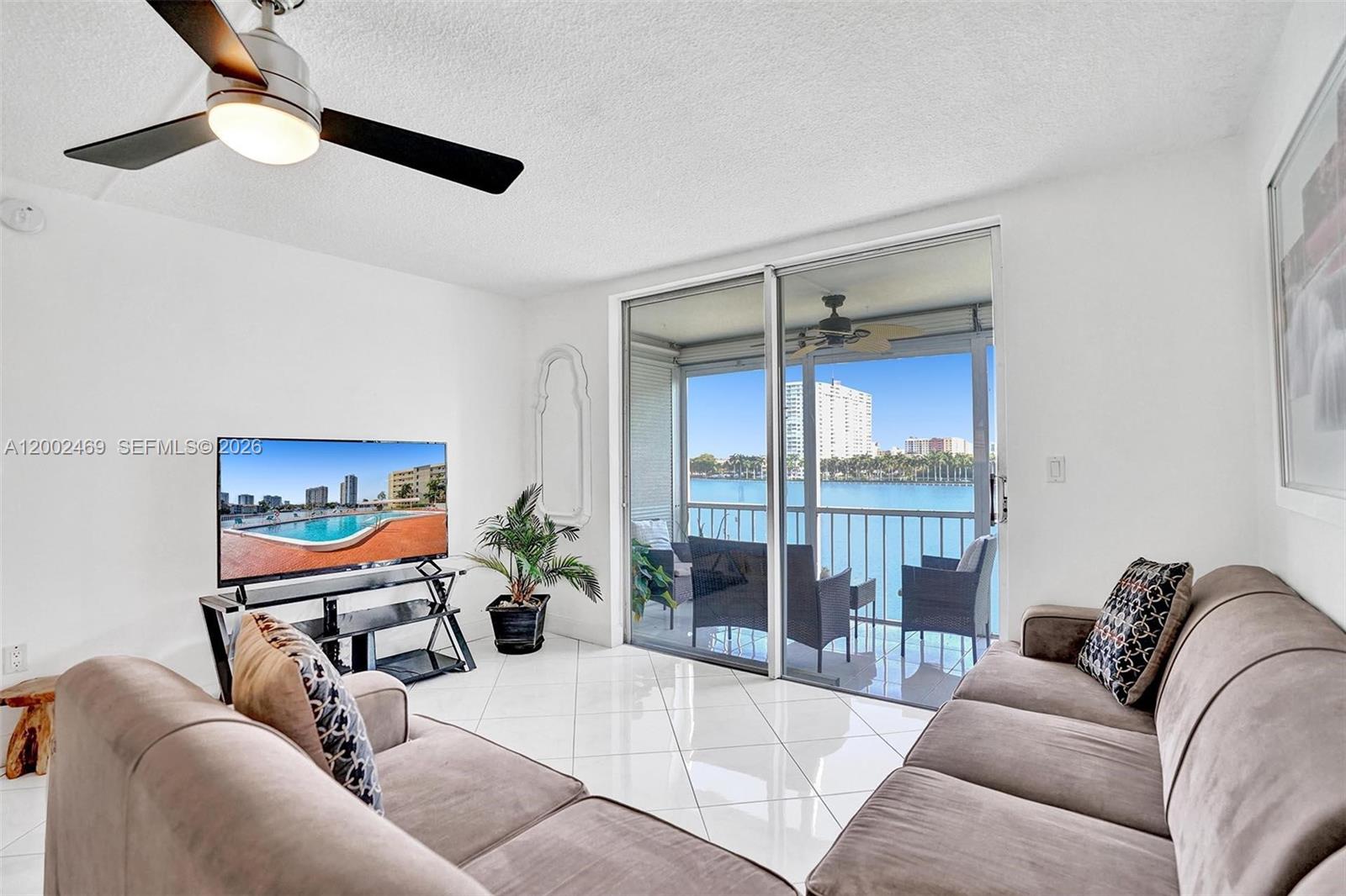 2999 Point E Drive, Unit C511 Aventura, FL 33160 - Photo 4 of 33 a living room with furniture a ceiling fan and a rug