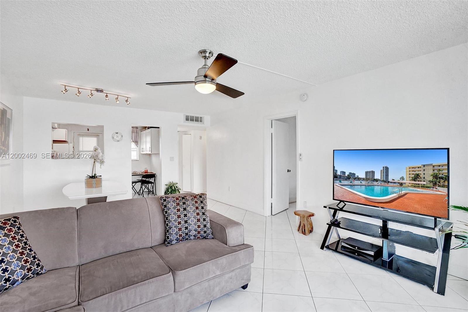 2999 Point E Drive, Unit C511 Aventura, FL 33160 - Photo 6 of 33 a living room with furniture and a ceiling fan