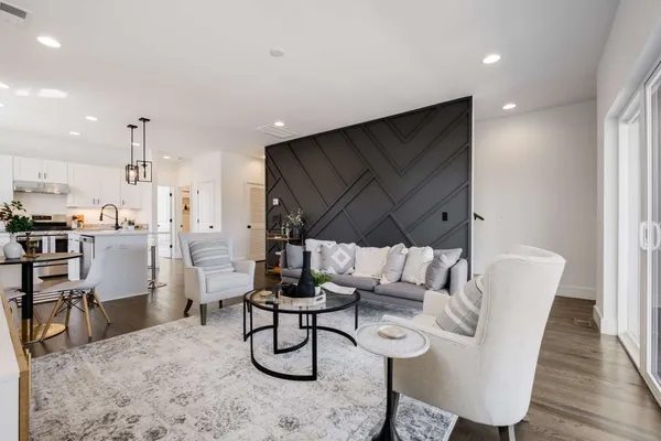a dining room with furniture and wooden floor