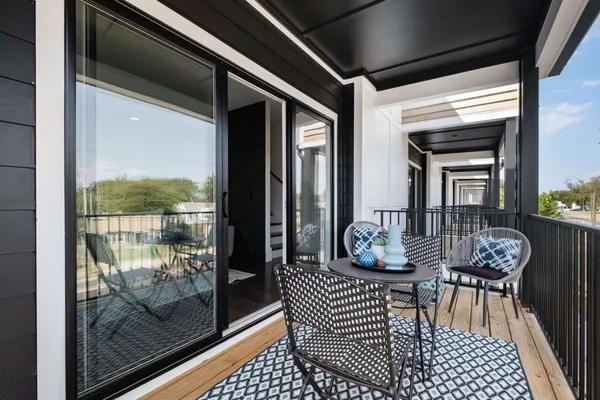 a view of a chairs and table in a balcony