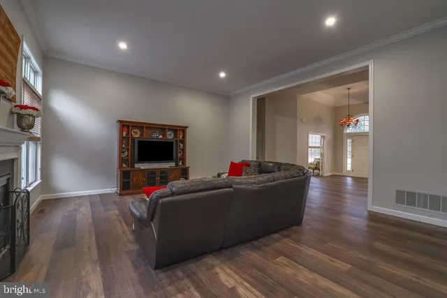 a kitchen with a dining table chairs and large windows