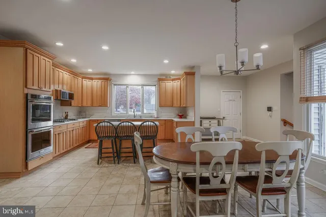 a large kitchen with a table and chairs