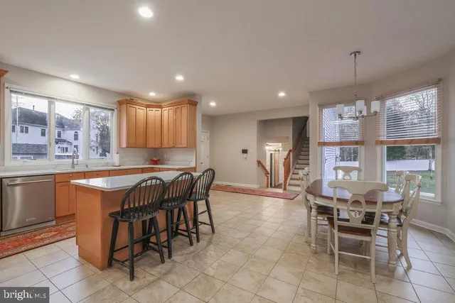 a kitchen with kitchen island granite countertop wooden cabinets a center island stainless steel appliances and a counter top space