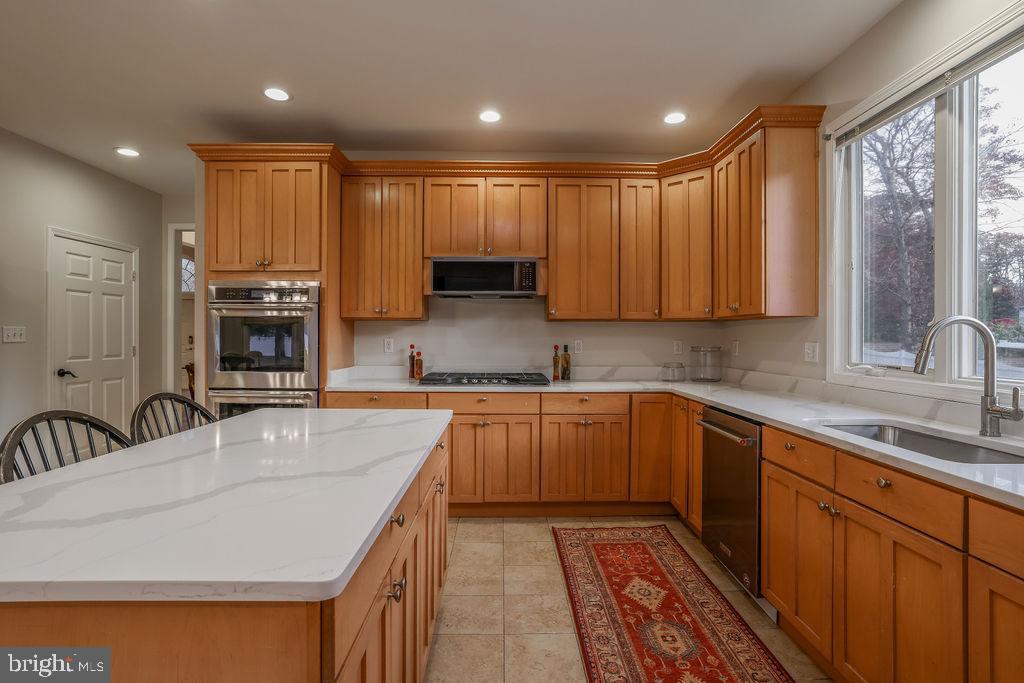 5 Popper Street Manahawkin, NJ 08050 - Photo 17 of 74 a kitchen with stainless steel appliances granite countertop a sink stove and cabinets