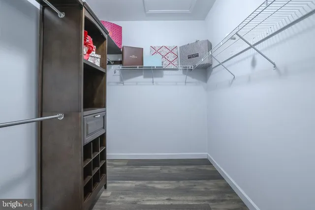 a view of a room with wooden floor and windows