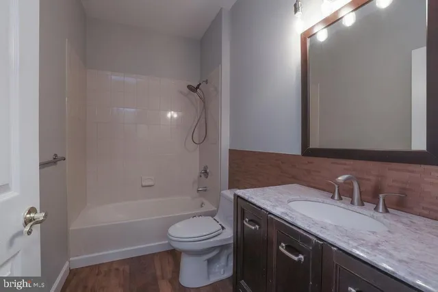 a view of a work space with wooden floor and furniture