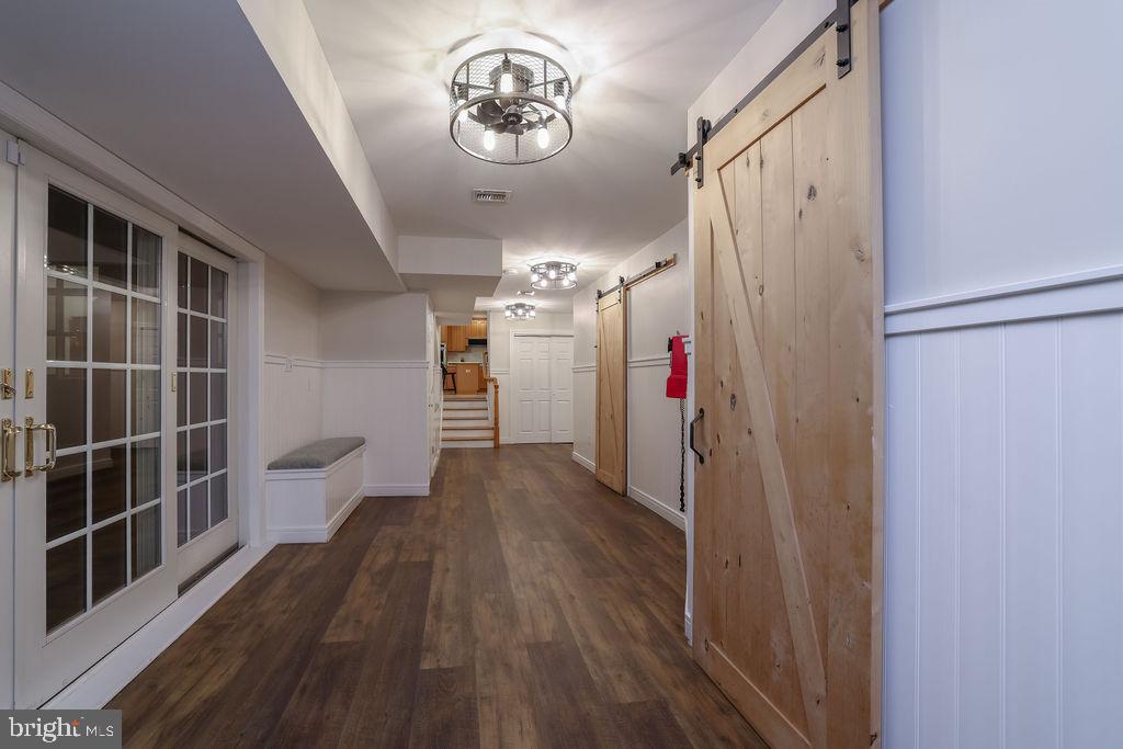 5 Popper Street Manahawkin, NJ 08050 - Photo 48 of 74 a view of a hallway with wooden floor and staircase