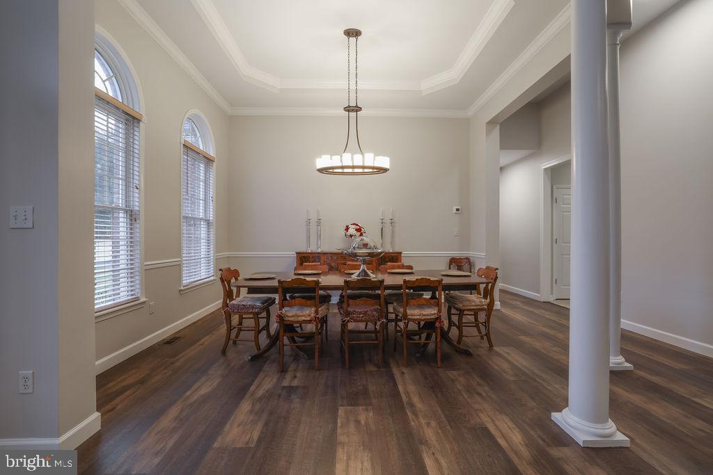5 Popper Street Manahawkin, NJ 08050 - Photo 9 of 74 a dining room with wooden floor a chandelier a wooden table and chairs