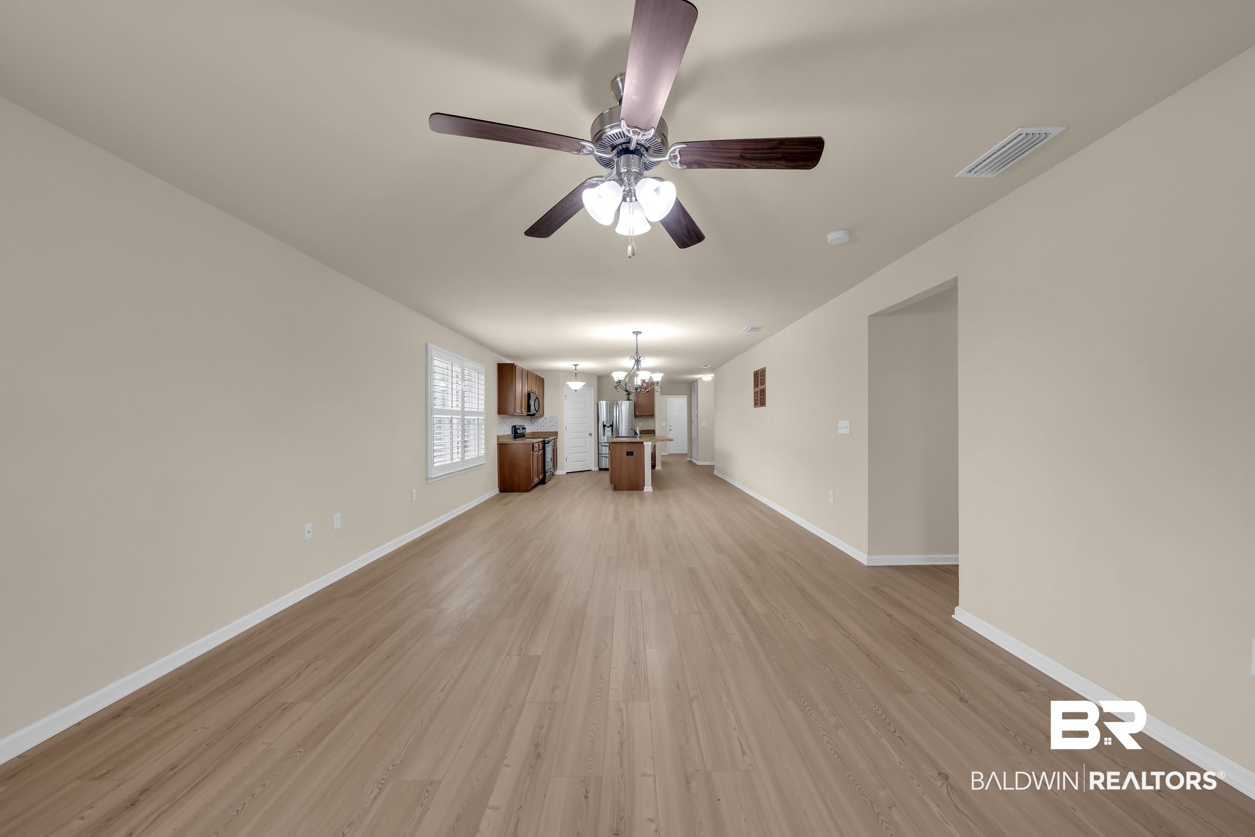 1704 Abbey Loop Foley, AL 36535 - Photo 13 of 38 Spacious interior featuring wood-finish flooring, neutral wall tones, and recessed lighting